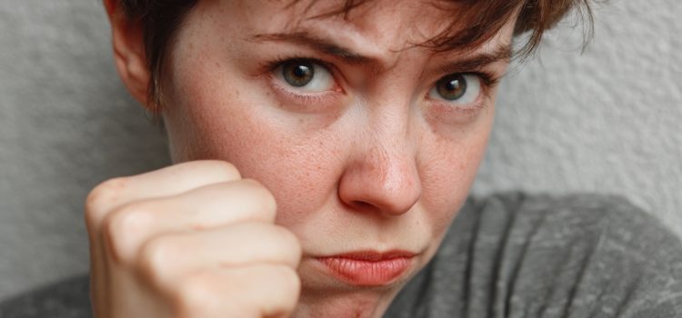 The Second Agreement: Don’t Take Anything Personally An offended woman putting up her fist illustrates the importance of the second agreement: Don't take anything personally