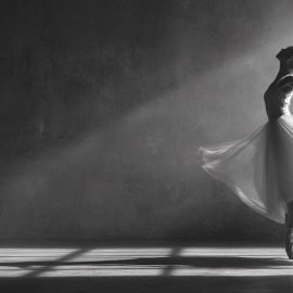 A ballet dancer in a flowing dress balancing on her tiptoes illustrates counterbalance instead of a balanced life