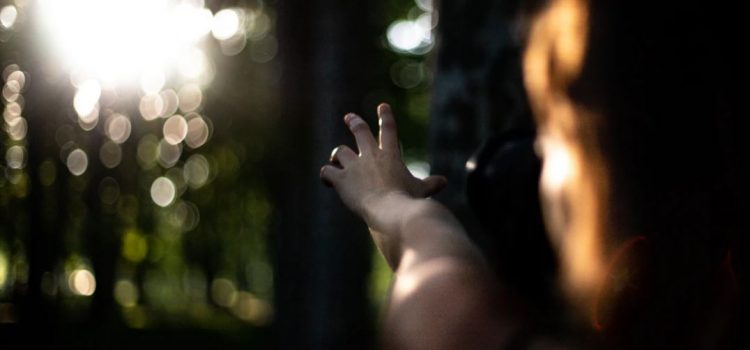 girl reaching towards the sunlight