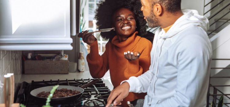 The Connection Between Relationships and Well-Being happy couple cooking