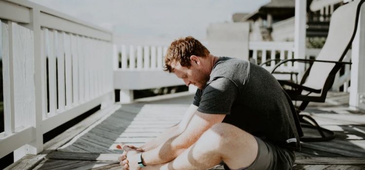 man doing yoga on porch