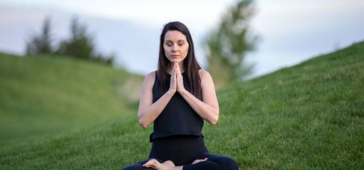 woman doing yoga in a field