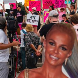 A cardboard cutout of Britney Spears in front of many people protesting outside for the Free Britney Movement.
