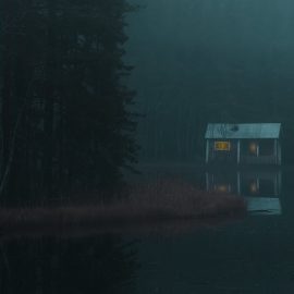 A dark image of a cabin in the woods by a lake.