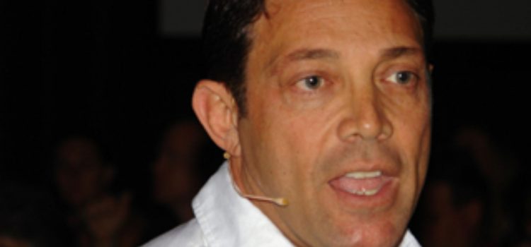 An image of Jordan Belfort with wireless microphone.