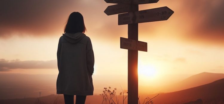 A woman choosing her own path at a crossroads sign during a sunset.