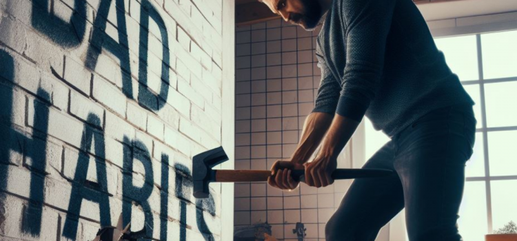 A man destroying a wall that says Bad Habits