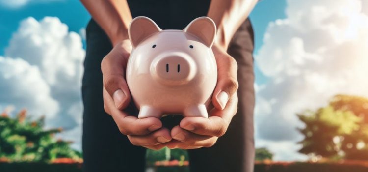 Hands holding a piggy bank outside