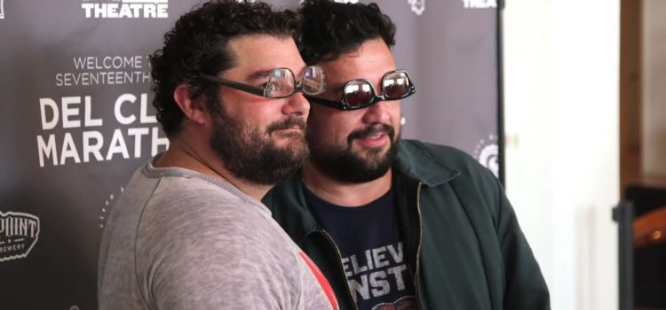 Bobby Moynihan and Horatio Sanz smiling for a photo with upside down glasses on