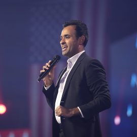 Vivek Ramaswamy speaking on stage at an event.