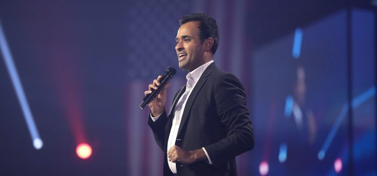 Vivek Ramaswamy speaking on stage at an event.