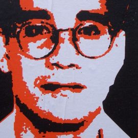 Red and white pop art poster of Andrew Cunanan wearing glasses.