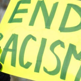 Sign that says end racism being held up at a protest