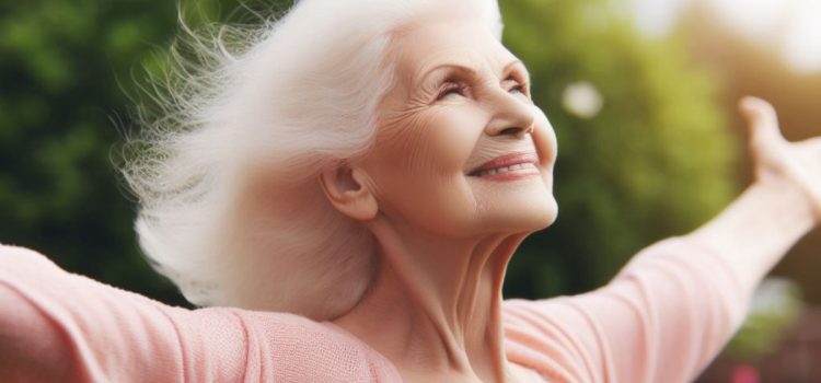 Super Aging & the Pursuit of Cognitive Longevity (Huberman Lab) a healthy smiling older white-haired woman - arms open wide - a super ager illustrating super aging and cognitive longevity