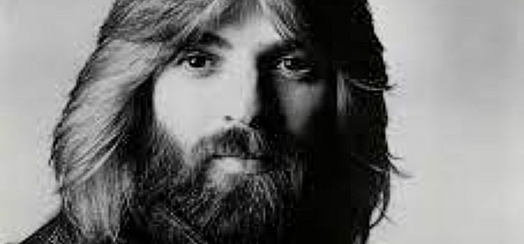 A black and white image of musician 1970s Kenny Loggins with long hair and a beard.