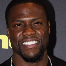 Kevin Hart smiling at a red carpet event.