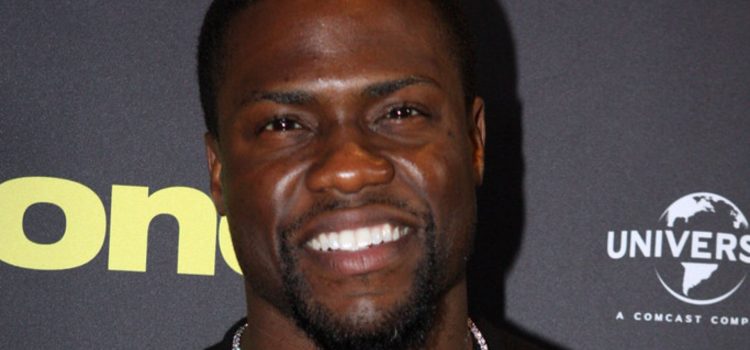 Kevin Hart smiling at a red carpet event.