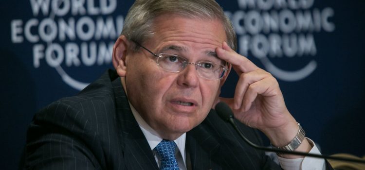 Robert Menendez looking stressed while speaking at a press conference.