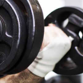 A man lifting weights at the gym.