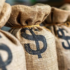 Bags of money with dollar signs used by money laundering criminals