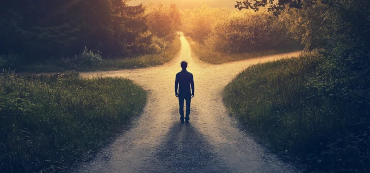 Why a Neuroscientist Recommends the Middle Way of Buddhism a person standing on a path that splits into three paths ahead illustrates the middle way of Buddhism