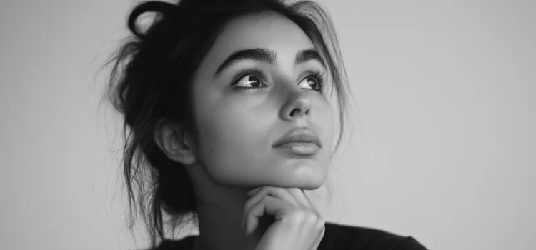 How to Always Be Curious as a Student of Life A woman holding her chin and looking up, showing how to always be curious
