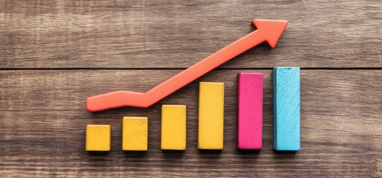How to Measure Progress: 3 Metrics for Businesses Building block bars progressively getting taller with an upward pointing arrow measuring progress