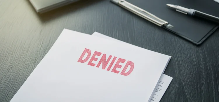 Why Is the US Healthcare System So Bad? Views From All Sides A document on a table that has the word "denied" stamped on it in red, referencing the bad healthcare in the US
