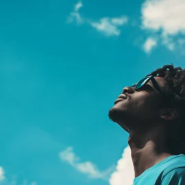 A man wondering what the human condition means, looking up at the sky