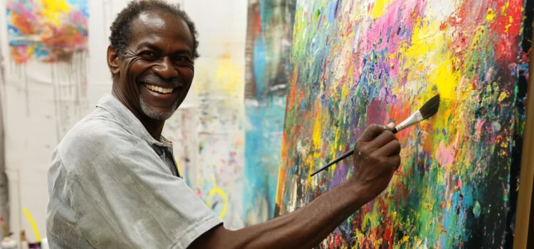 Follow Your Desires: A Crucial Step Toward Immense Growth A happy man painting on a canvas in an art studio who is following his desires