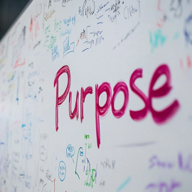 The word "Purpose" written on a whiteboard