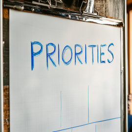 A whiteboard with the word "PRIORITIES" on it to show how to set priorities in life