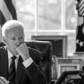 President Joe Biden sitting at his desk in the Oval Office