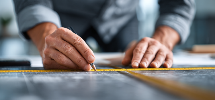 How to Measure Anything by Douglas W. Hubbard: Overview A businessman measuring with a ruler on a table