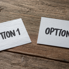 Two sheets of paper on a table that read OPTION 1 and OPTION 2