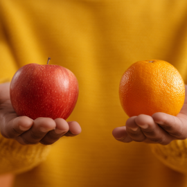 An uncertain person struggling between an apple and orange