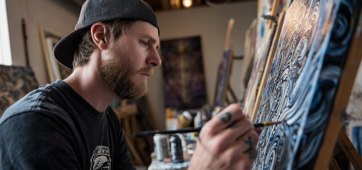 A creative person creating a painting on a canvas