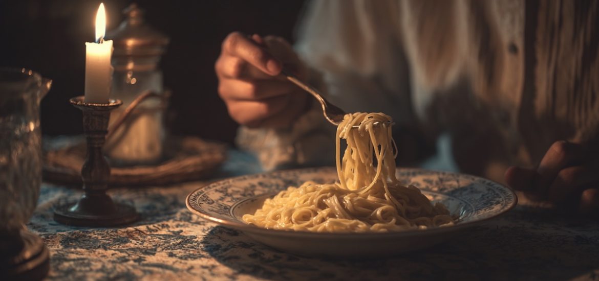 The hands of a person eating pasta by candlelight illustrates strategies for managing cortisol levels