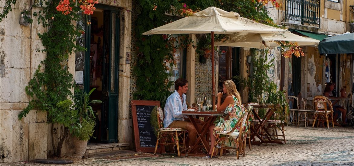 A couple enjoying mini-retirement are dining at an outdoor cafe in Europe