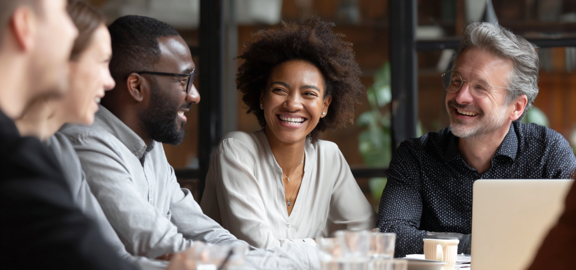 A diverse real estate team sitting around a table in a meeting