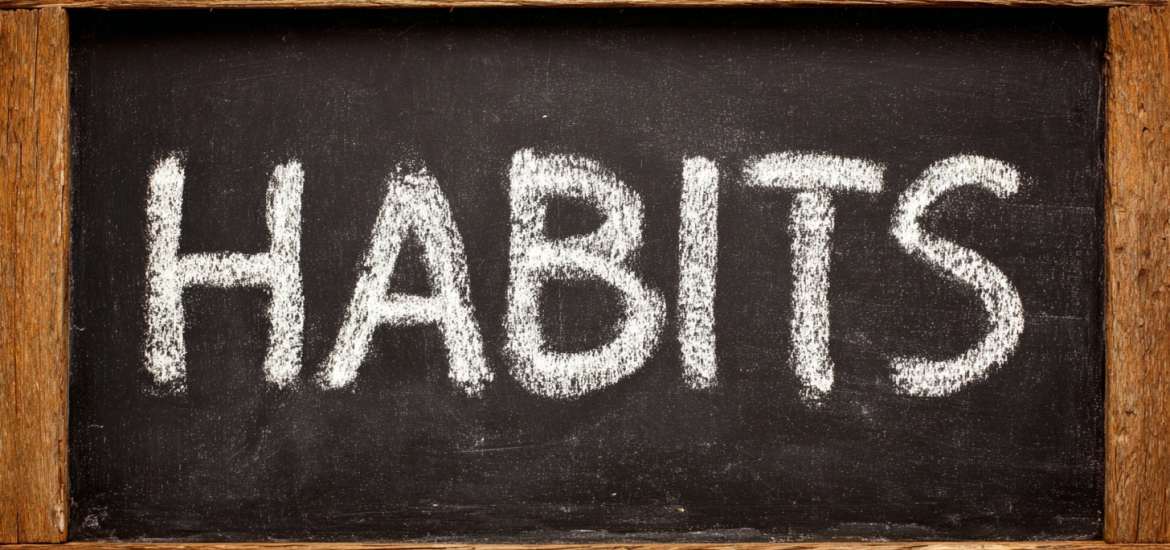 The word "HABITS" written on a chalkboard
