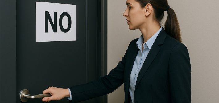 A professional woman with her hand on the handle of a door with a sign that says NO depicts how to handle rejection in sales