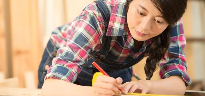 A woman finding her ikigai while woodworking in a workshop