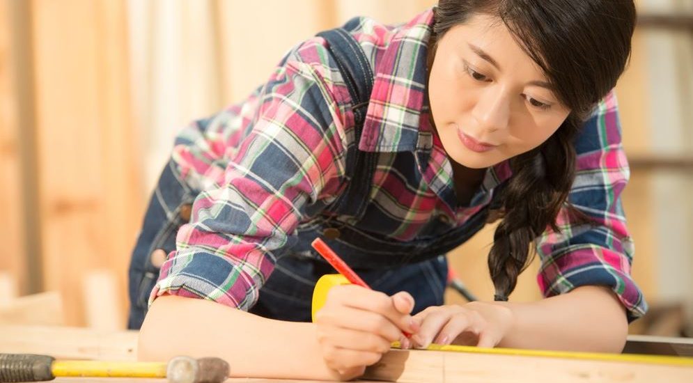 A woman finding her ikigai while woodworking in a workshop