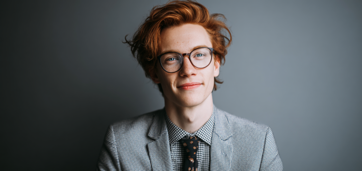 A young person in a business suit looking for career advice for young professionals