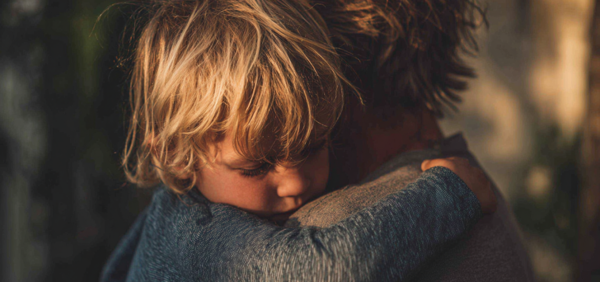 A parent and child hugging, practicing conscious parenting